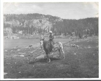 Untitled, mounted woman near a lake