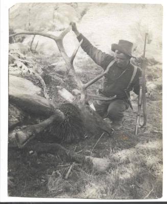 Carl Rungius with a large dead elk