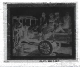 Untitled-negative of 4 men and one woman witting on a truck bed.