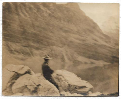 Untitled - man sitting on rocks