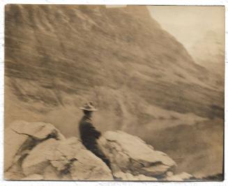 Untitled - man sitting on rocks