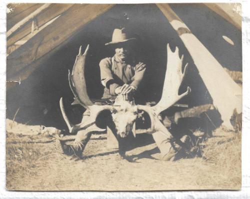 B&W photo of Rungius in front of a tent